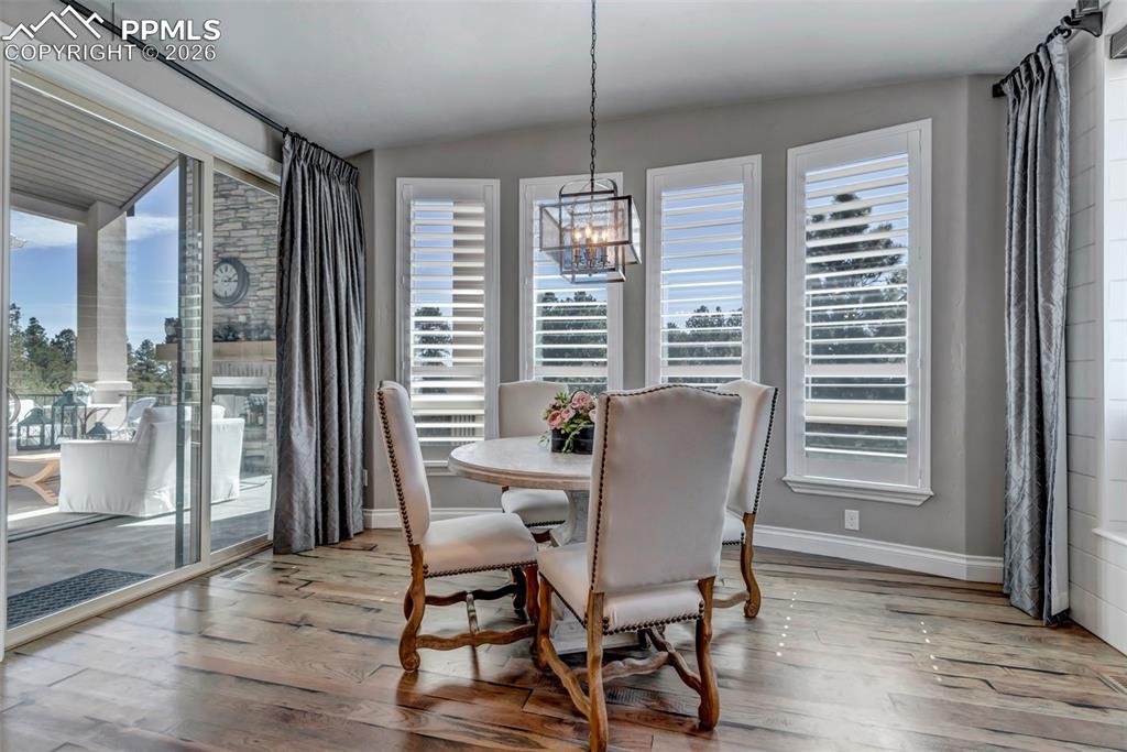 Image 28 of 50: Kitchen featuring two tone cabinetry, open floor plan, stainless steel appl