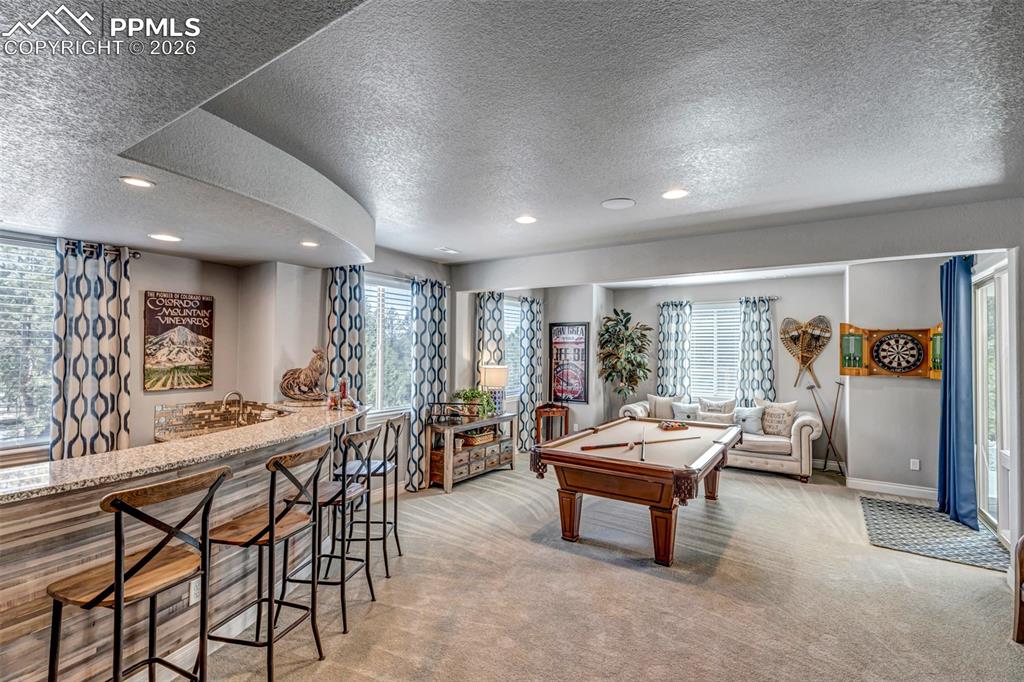 Image 33 of 50: View of patio / terrace featuring an outdoor living space with a fireplace