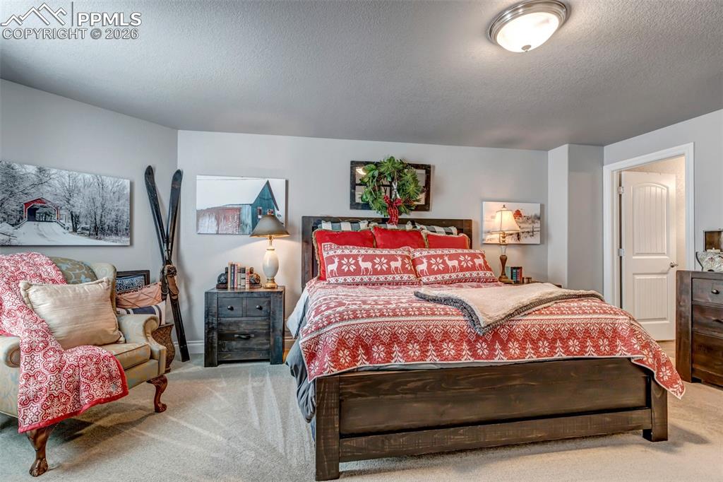 Image 39 of 50: Carpeted cinema room with a raised ceiling, ornamental molding, and recesse