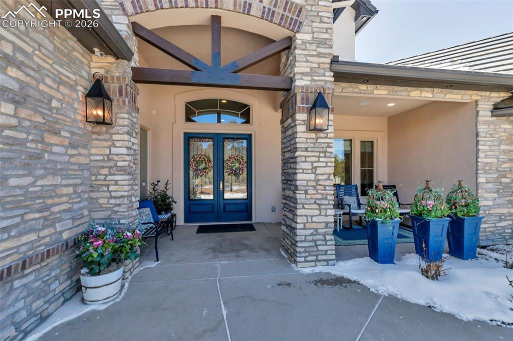 Image 4 of 50: Aerial view of property and surrounding area featuring a tree filled landsc