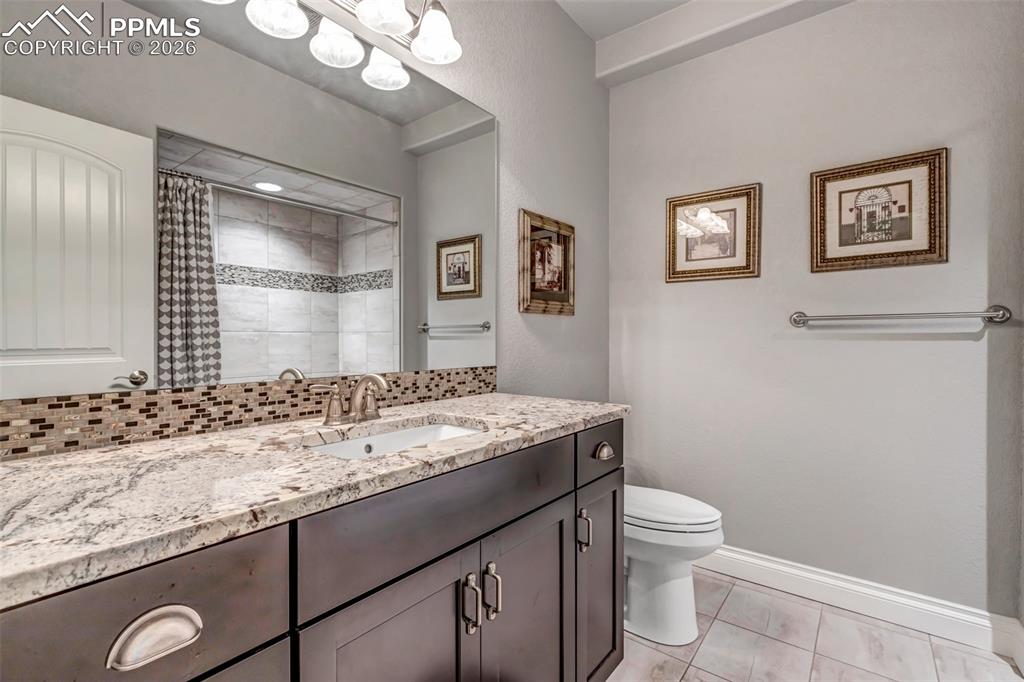 Image 41 of 50: Bedroom with a textured ceiling, light carpet, and multiple windows