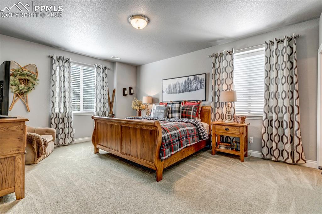Image 44 of 50: Bathroom with vanity, tasteful backsplash, curtained shower, and light tile
