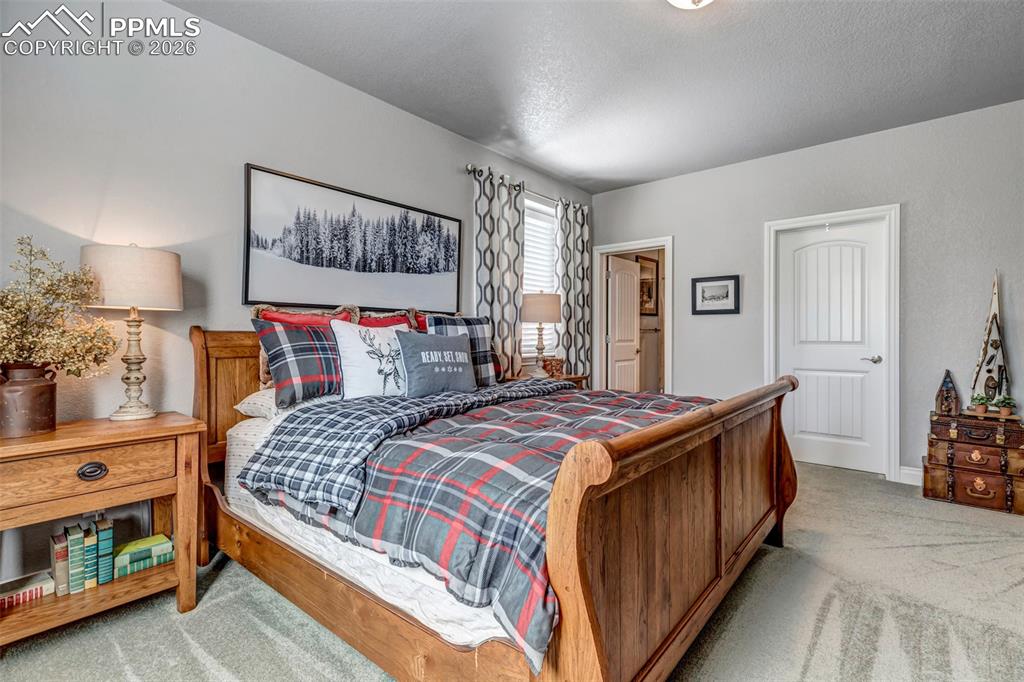 Image 45 of 50: Carpeted bedroom featuring a textured ceiling