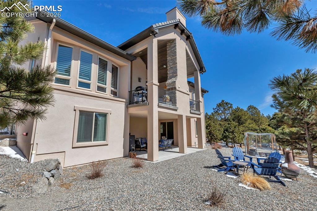 Image 47 of 50: Bedroom featuring light colored carpet, a textured ceiling, and multiple wi