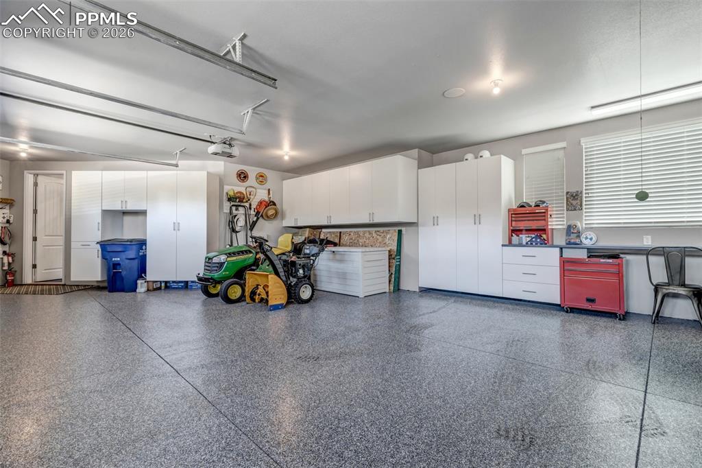 Image 49 of 50: Back of property with a patio area, stucco siding, a fire pit, a chimney, a