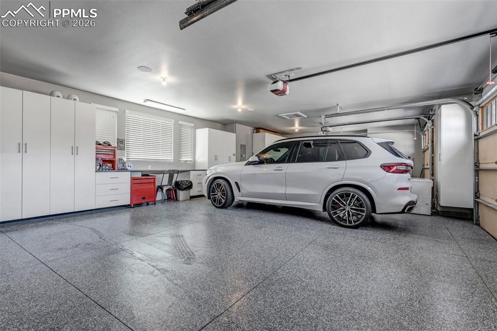 Image 50 of 50: Rear view of house with a patio, stucco siding, a balcony, and a chimney