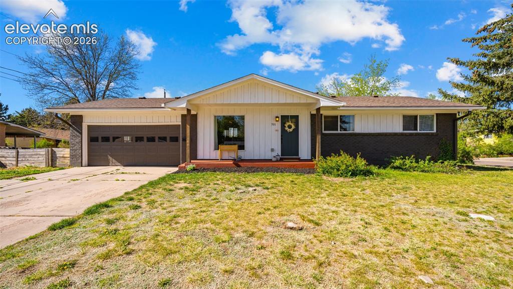 Image 2 of 43: Ranch-style exterior featuring a dark brick facade, white vertical siding,
