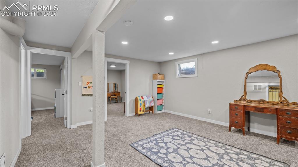 Image 20 of 42: Spacious carpeted room featuring recessed lighting, light gray walls, and a