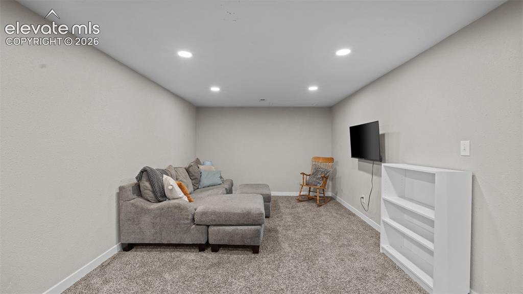 Image 27 of 43: Spacious room featuring neutral carpeting and light-toned walls