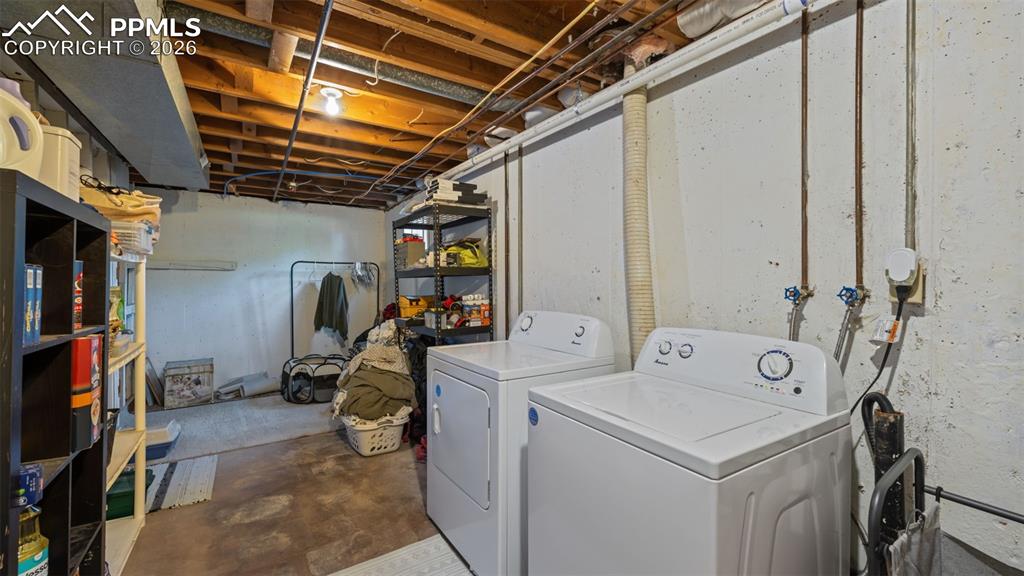 Image 28 of 42: Lower level utility area featuring a concrete floor, exposed ceiling joists