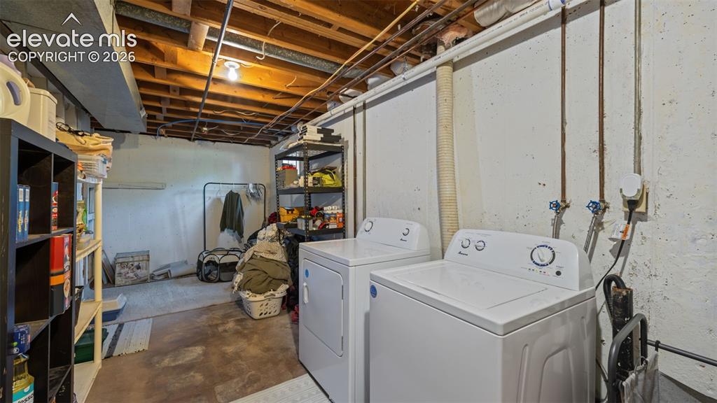 Image 29 of 43: Lower level utility area featuring a concrete floor, exposed ceiling joists