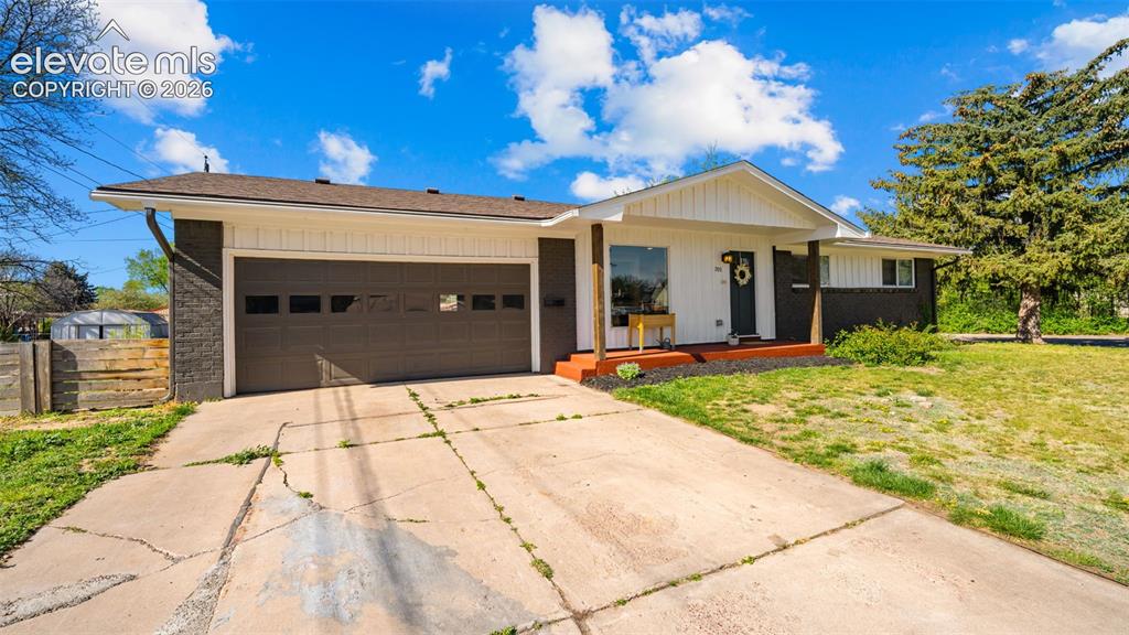 Image 3 of 43: Single-story residence featuring a two-car garage with horizontal panel doo
