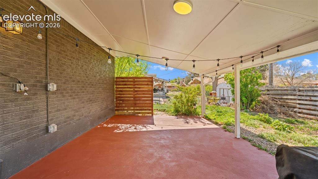 Image 30 of 43: Covered patio featuring a red-toned concrete surface