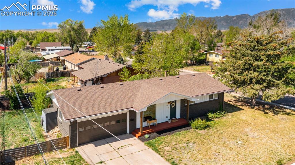 Image 34 of 42: Ranch-style residence featuring a two-car garage, dark exterior siding, a w