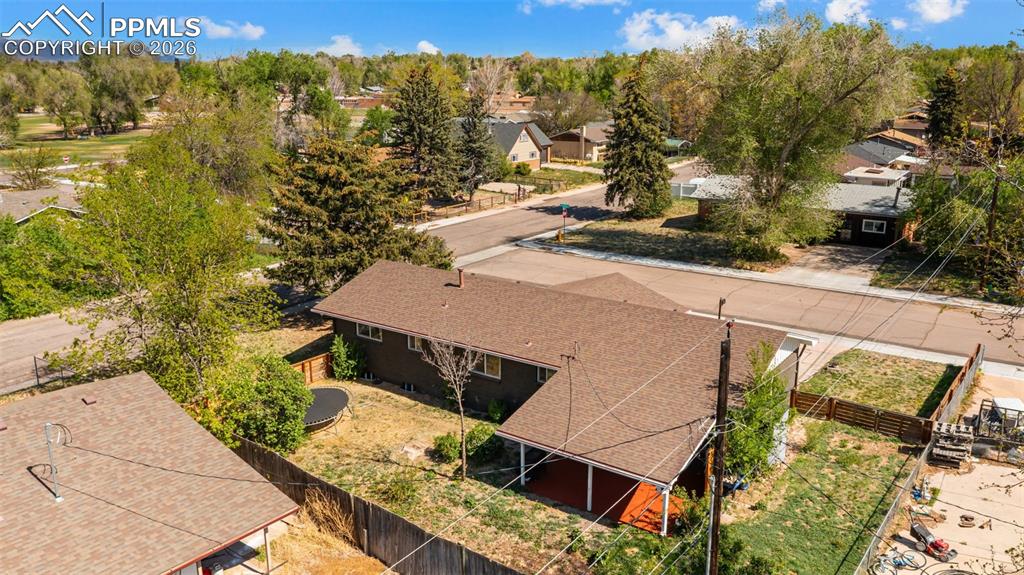Image 36 of 42: Brown shingle roofing with a covered patio featuring a red-hued deck