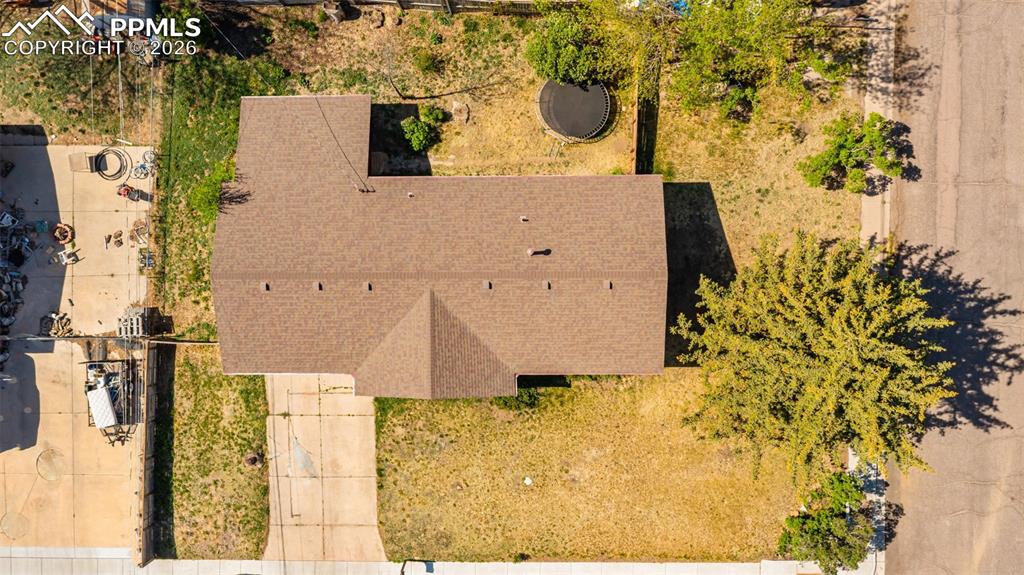 Image 38 of 42: Residential property featuring a brown shingle roof, asphalt driveway, and 
