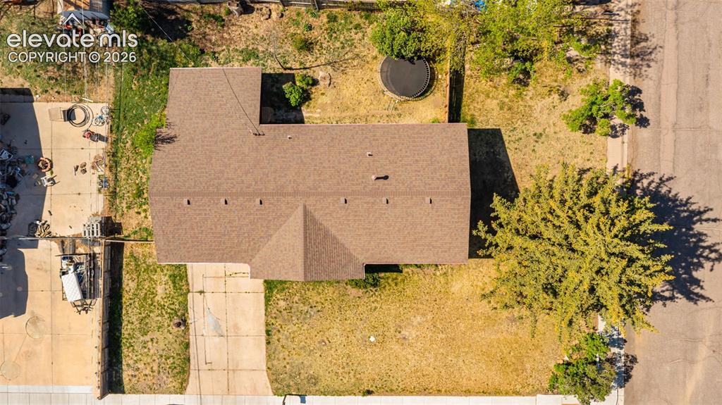 Image 39 of 43: Residential property featuring a brown shingle roof, asphalt driveway, and