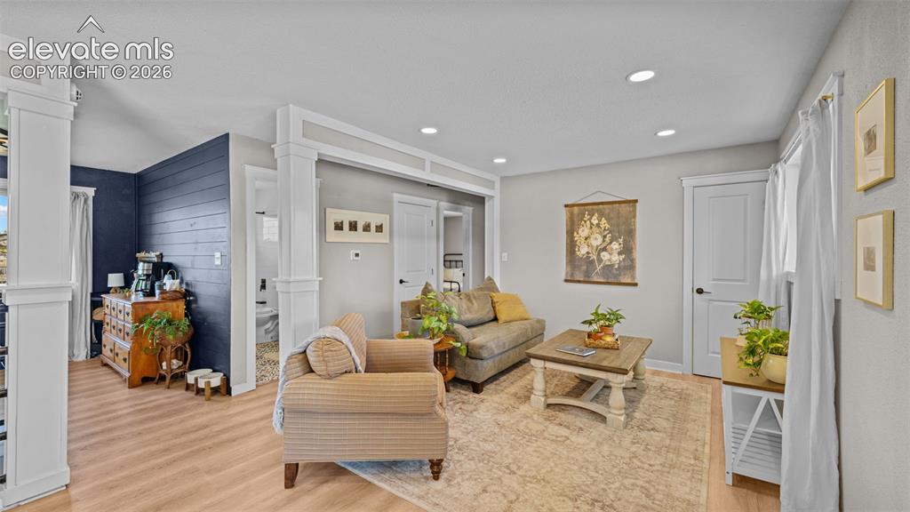 Image 5 of 43: Spacious living area featuring light wood-finish flooring, recessed lightin