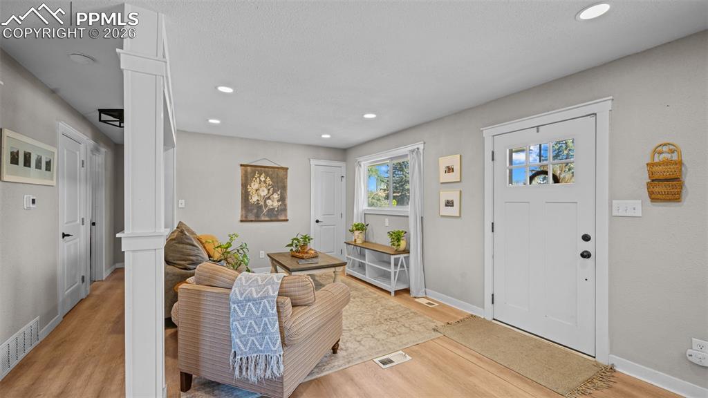 Image 6 of 42: Living area featuring light wood-finish flooring, recessed lighting, a whit