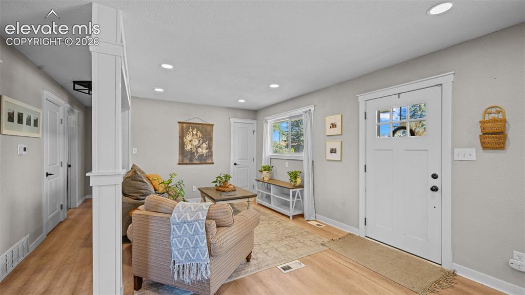 Image 7 of 43: Living area featuring light wood-finish flooring, recessed lighting, a whit