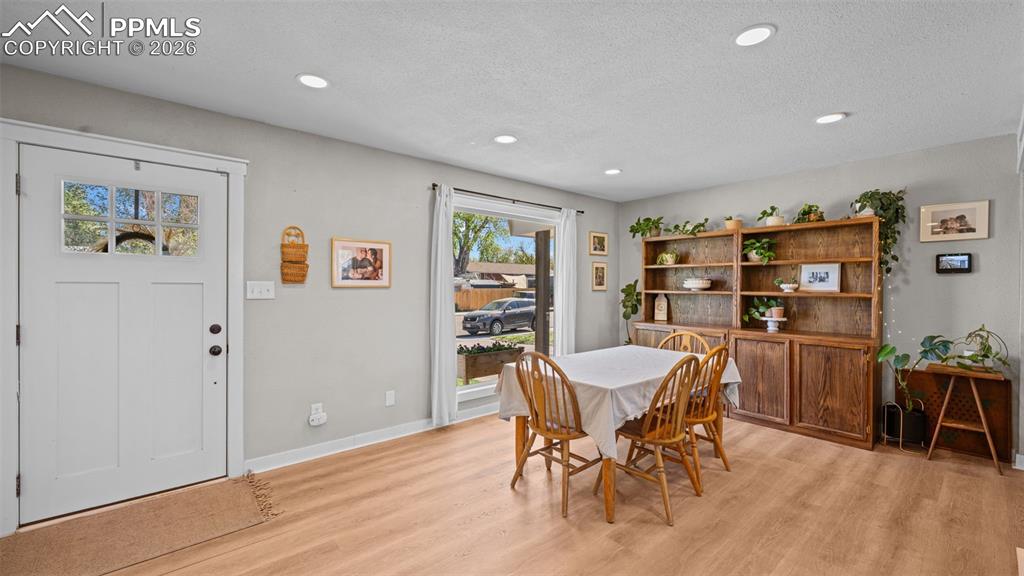 Image 9 of 42: Open concept living space featuring wood-finish flooring, recessed lighting
