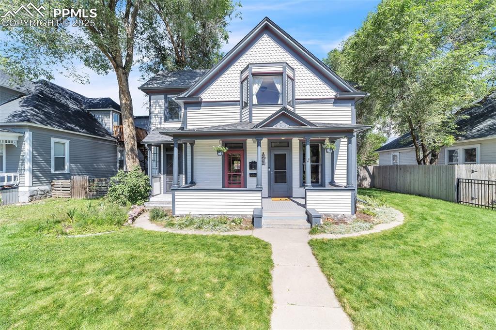 Caption: Victorian-style house featuring a porch