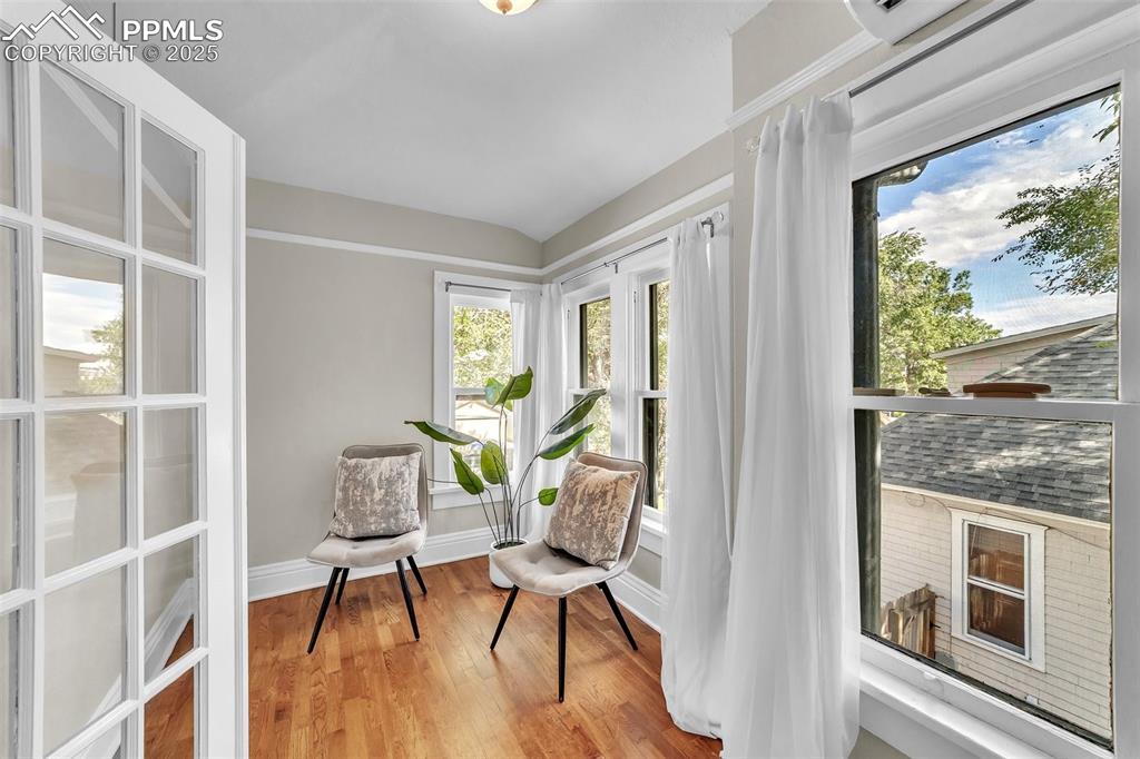 Image 26 of 49: Sitting room off the bedroom featuring wood floors and vaulted ceiling