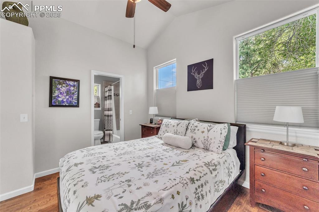 Image 37 of 49: Apartment: Bedroom with wood finished floors, lofted ceiling, ensuite bathr