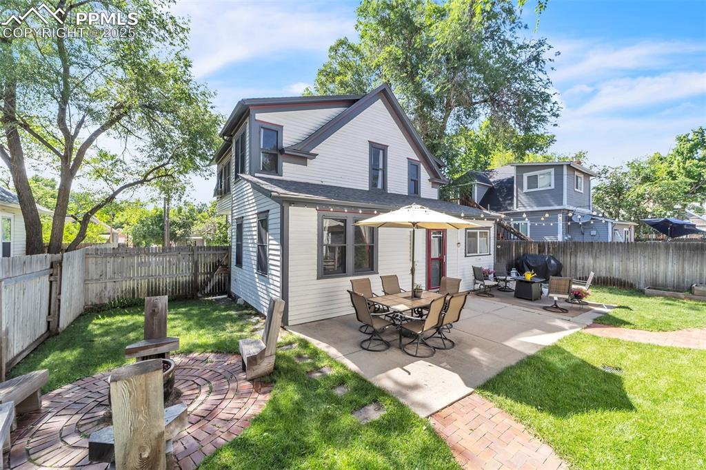 Image 38 of 49: Back of house with a fenced backyard, an outdoor hangout area, and a patio
