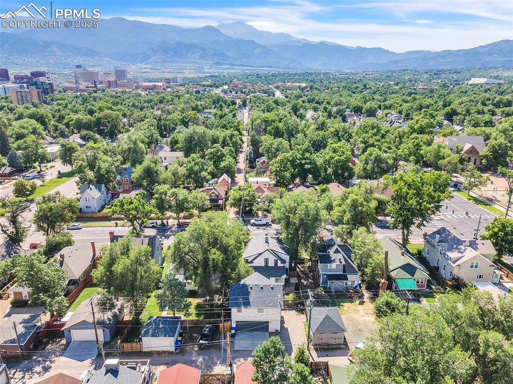 Image 43 of 49: Aerial view of residential area featuring a mountain backdrop