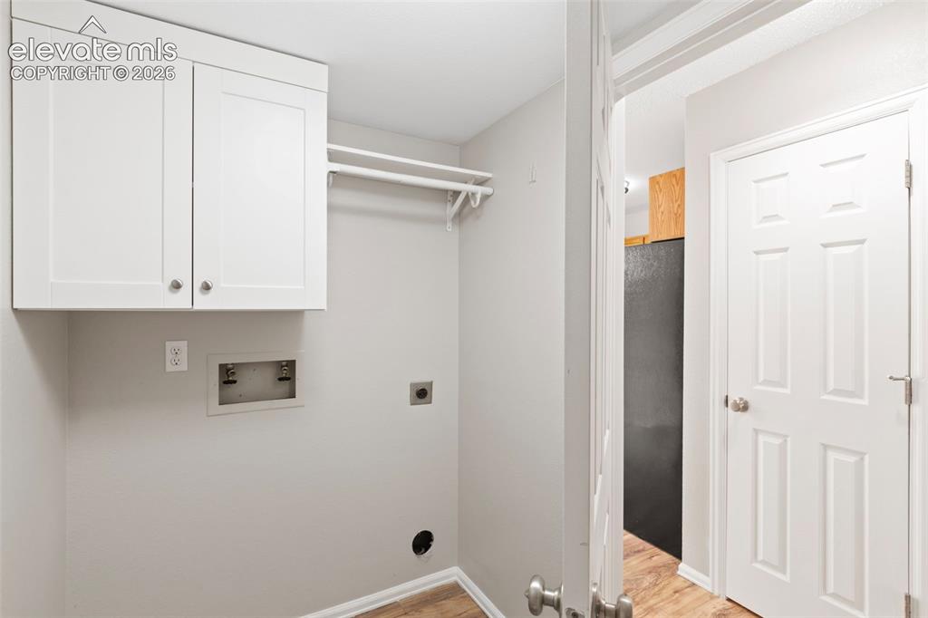 Image 16 of 30: Built-in storage in the laundry area