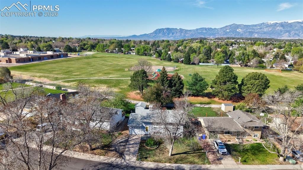 Image 31 of 41: Aerial View of the home with open space behind