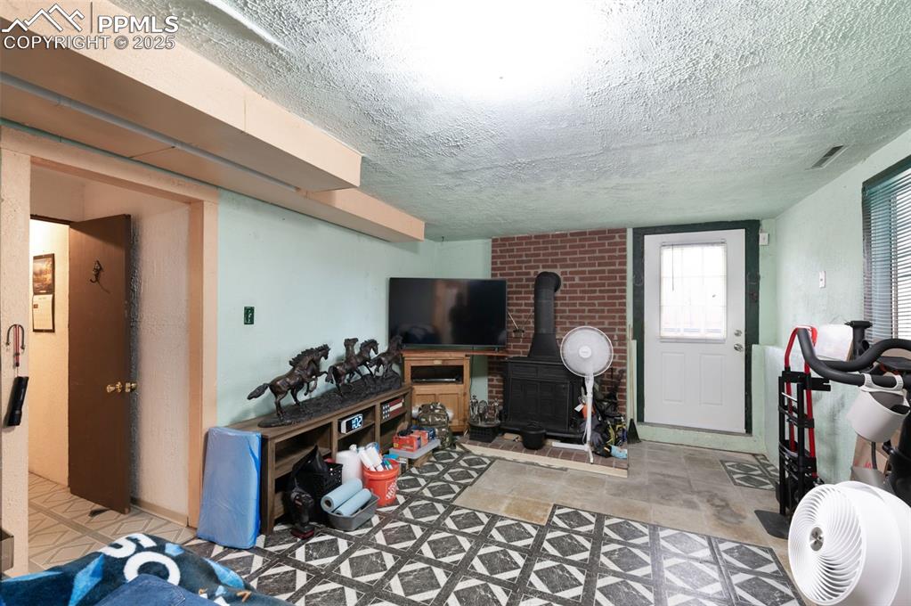 Image 32 of 50: Basement Living Room Area With Walk Out