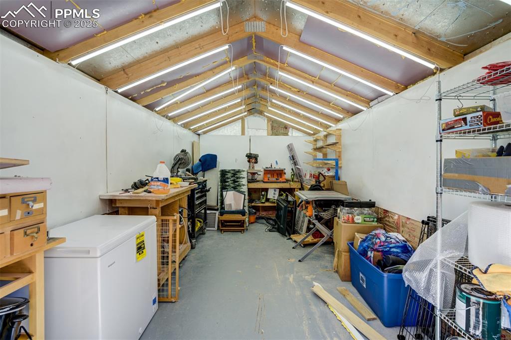 Image 36 of 41: Insulated shed with shelving and shop lights