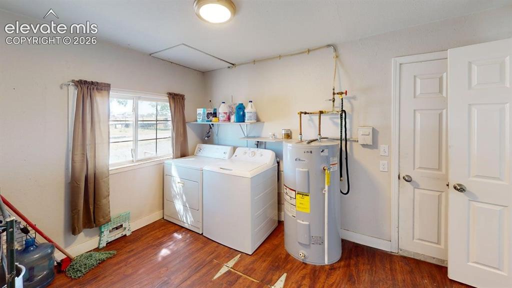 Image 19 of 23: Laundry area featuring wood-finish flooring, a window, and overhead lightin