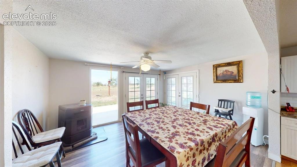 Image 7 of 23: Built-in stove with hearth pad, wood-finish flooring, ceiling fan, and mult
