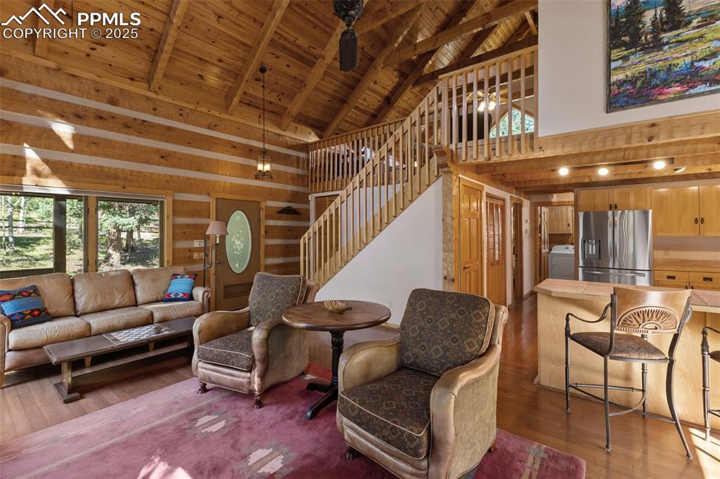 Image 10 of 46: Tongue and Groove Vaulted Ceiling with Hand Hewn Trusses