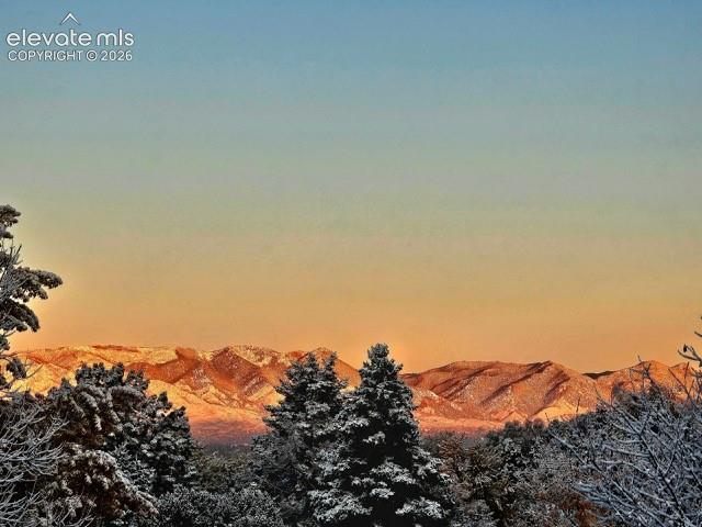 Image 13 of 26: Snow-dusted mountain range view from the master bathroom!