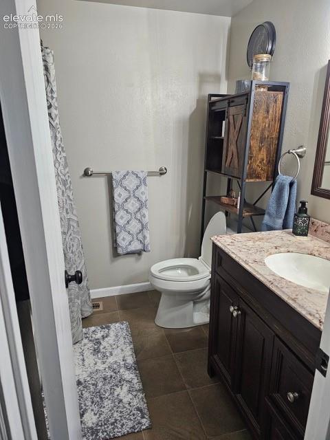 Image 17 of 26: Upper Bathroom featuring a dark wood-finish vanity with a light-toned count