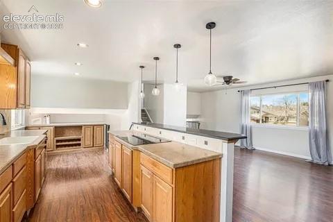 Image 9 of 26: Open-concept kitchen featuring wood-finish flooring, light wood cabinetry,