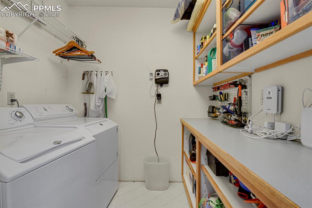 Image 20 of 34: Large laundry room with buit-ins and counter space/desk