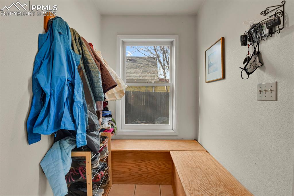 Image 21 of 34: Mudroom off the back-door with custom built-in bench