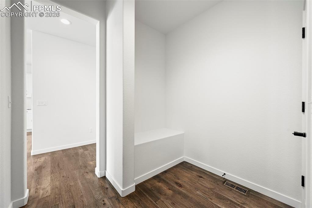 Image 16 of 37: Entryway featuring wood-finish flooring and a built-in bench