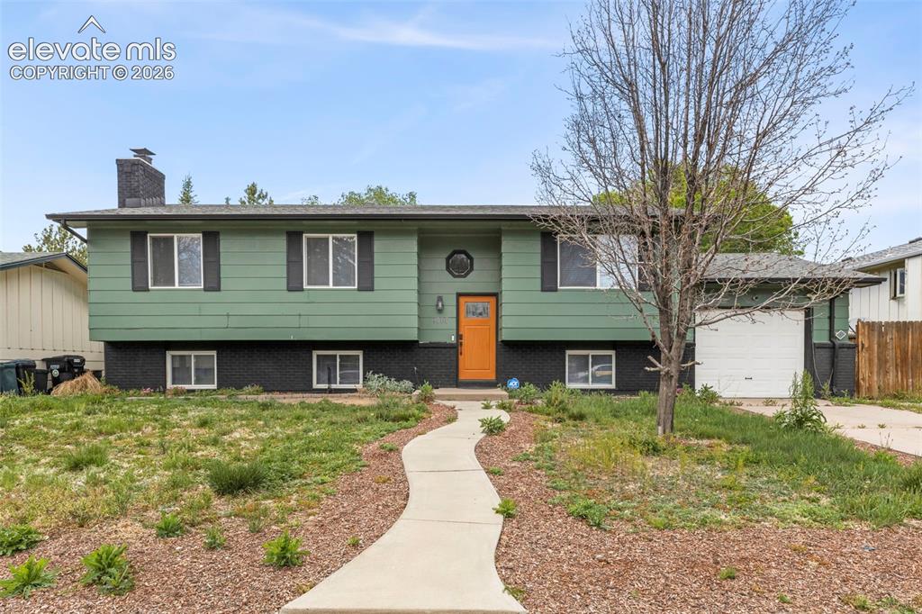 Caption: Front of property with one car garage