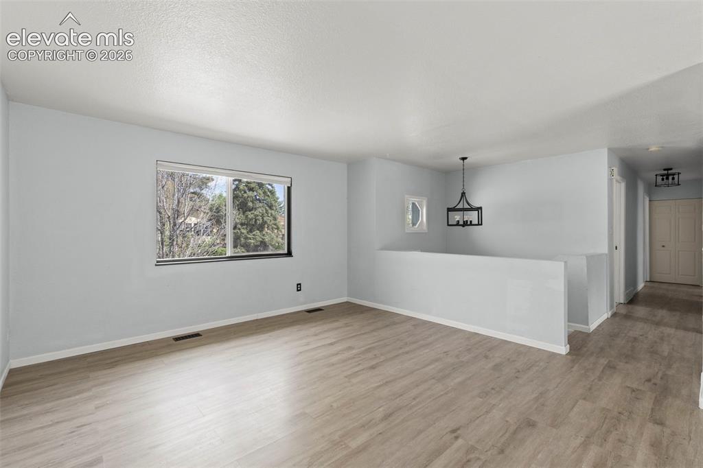 Image 5 of 24: Living area with natural light and flooring