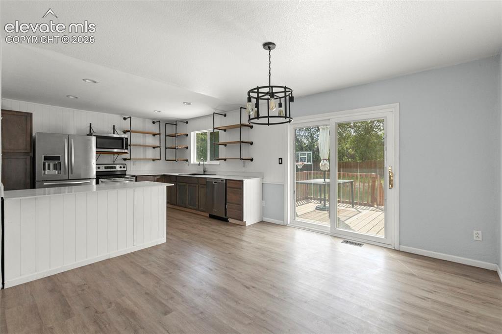 Image 6 of 24: dinging area and kitchen