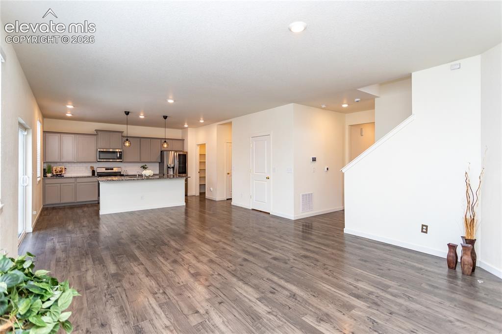 Image 10 of 48: Living room flows into the dining area and the kitchen.