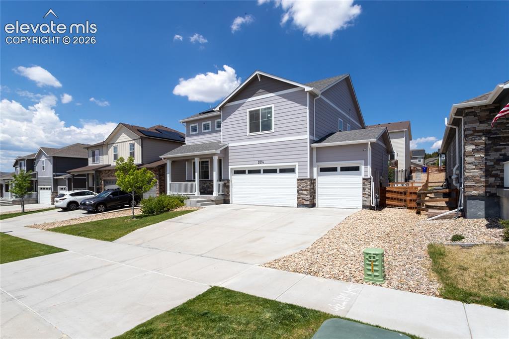 Image 2 of 48: 3 car garage is drywalled and offers high-lift jacks for the garage doors a