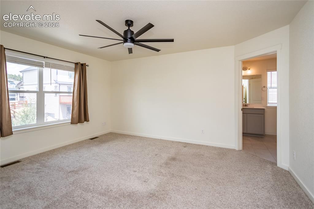 Image 21 of 48: Generously sized primary suite with adjoining bathroom.