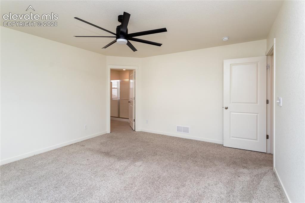 Image 22 of 48: Another view of the primary bedroom